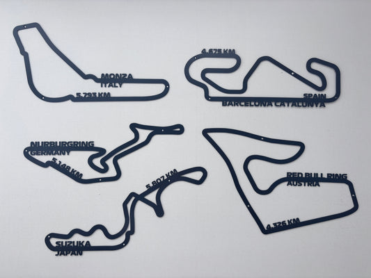 Custom laser-cut steel wall art of F1 circuits including Monza and Suzuka