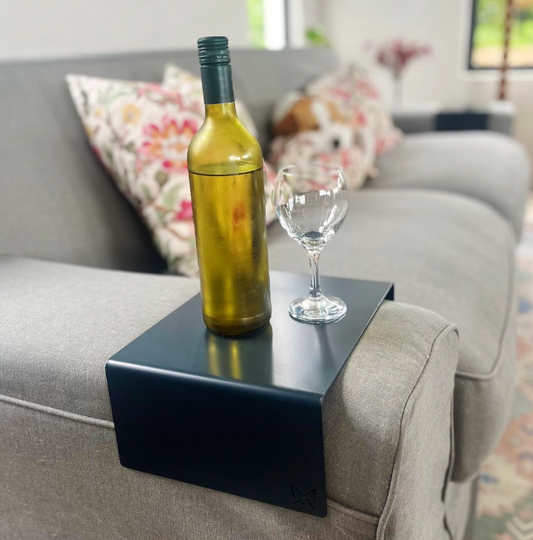 Custom steel armrest table sized to fit a sofa