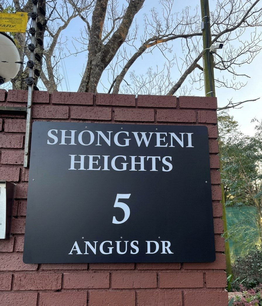 New black steel entrance sign for Shongweni Heights, 5 Angus Drive, Hillcrest, on a brick gate pillar