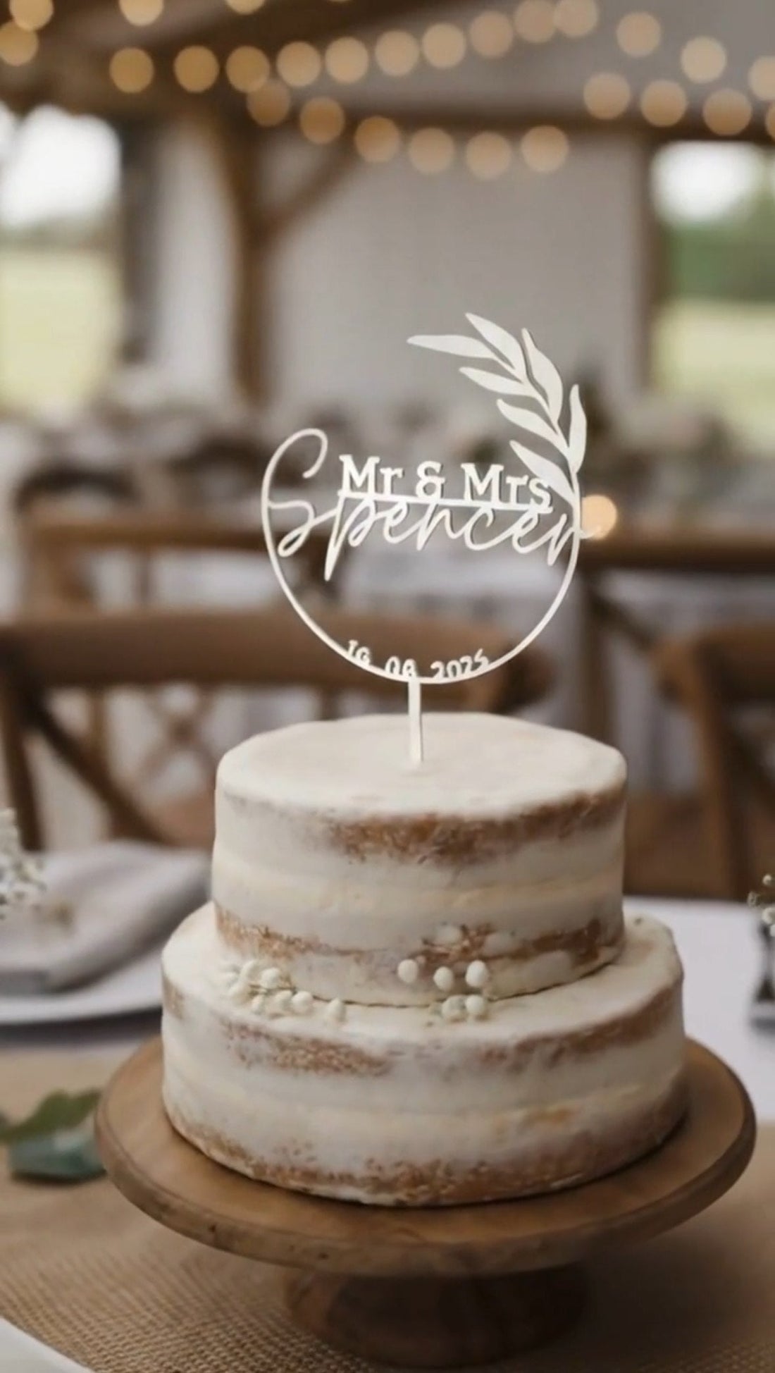 Personalised white steel Mr & Mrs wedding cake topper with a leaf motif and wedding date